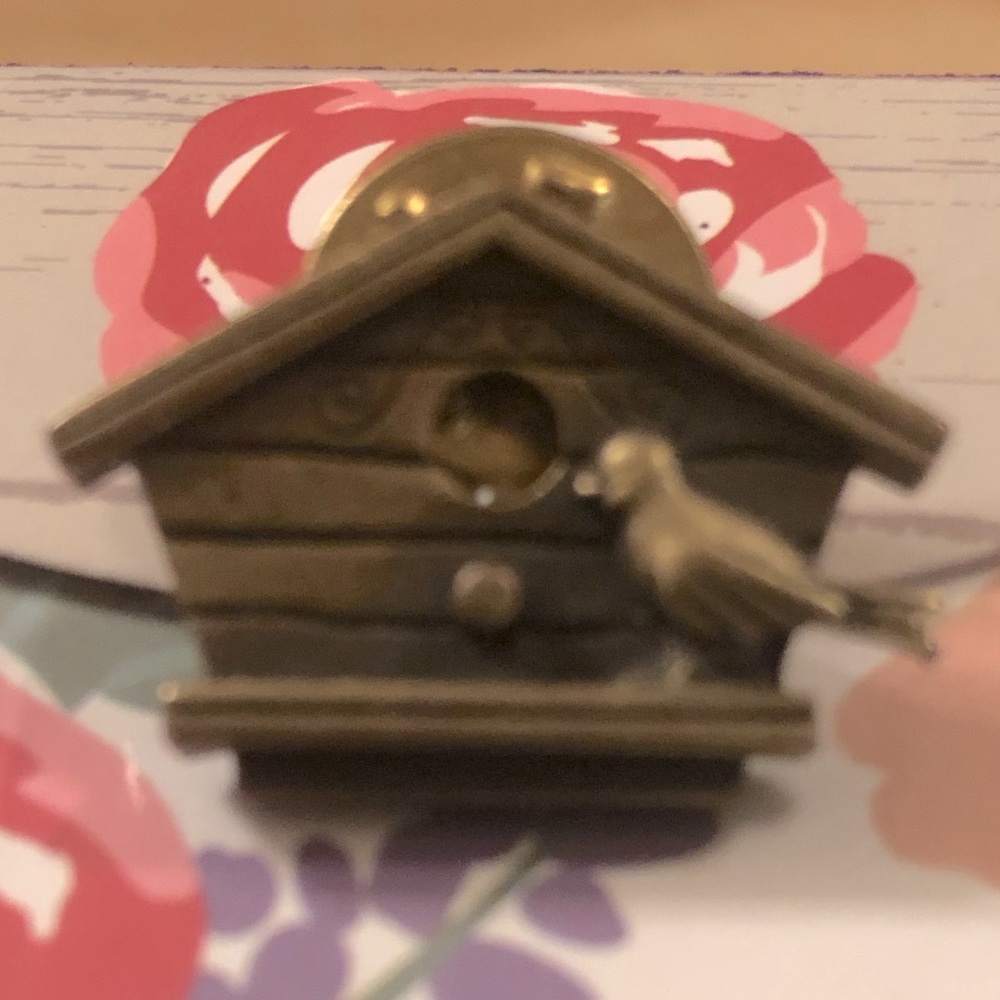 Very cute brass color birdhouse lapel pin.
